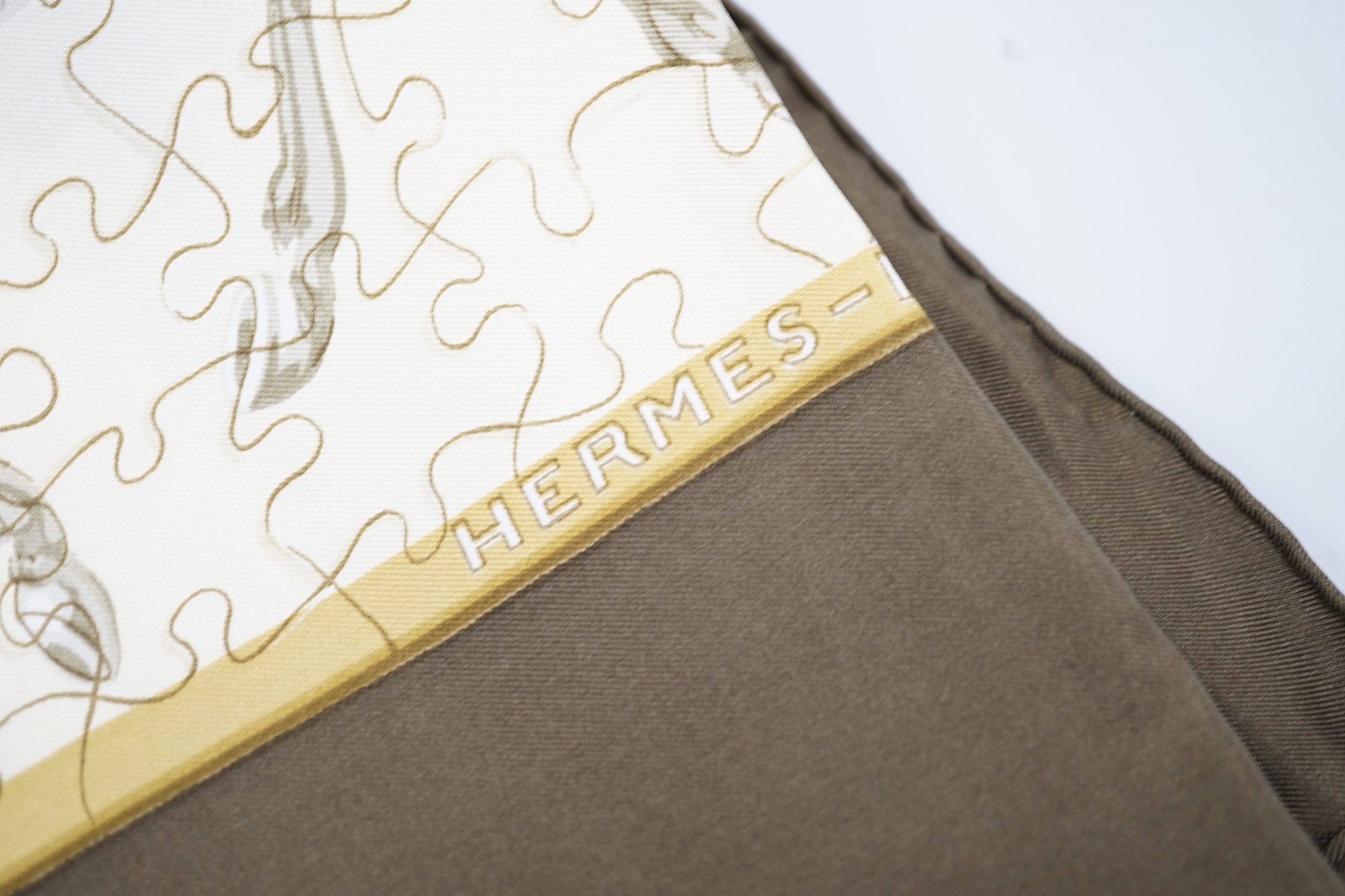 Four vintage Hermes silk scarves including two retailed by Harrods comprising Cuivreries, Roues de Canon, Napoleon and Puzzle